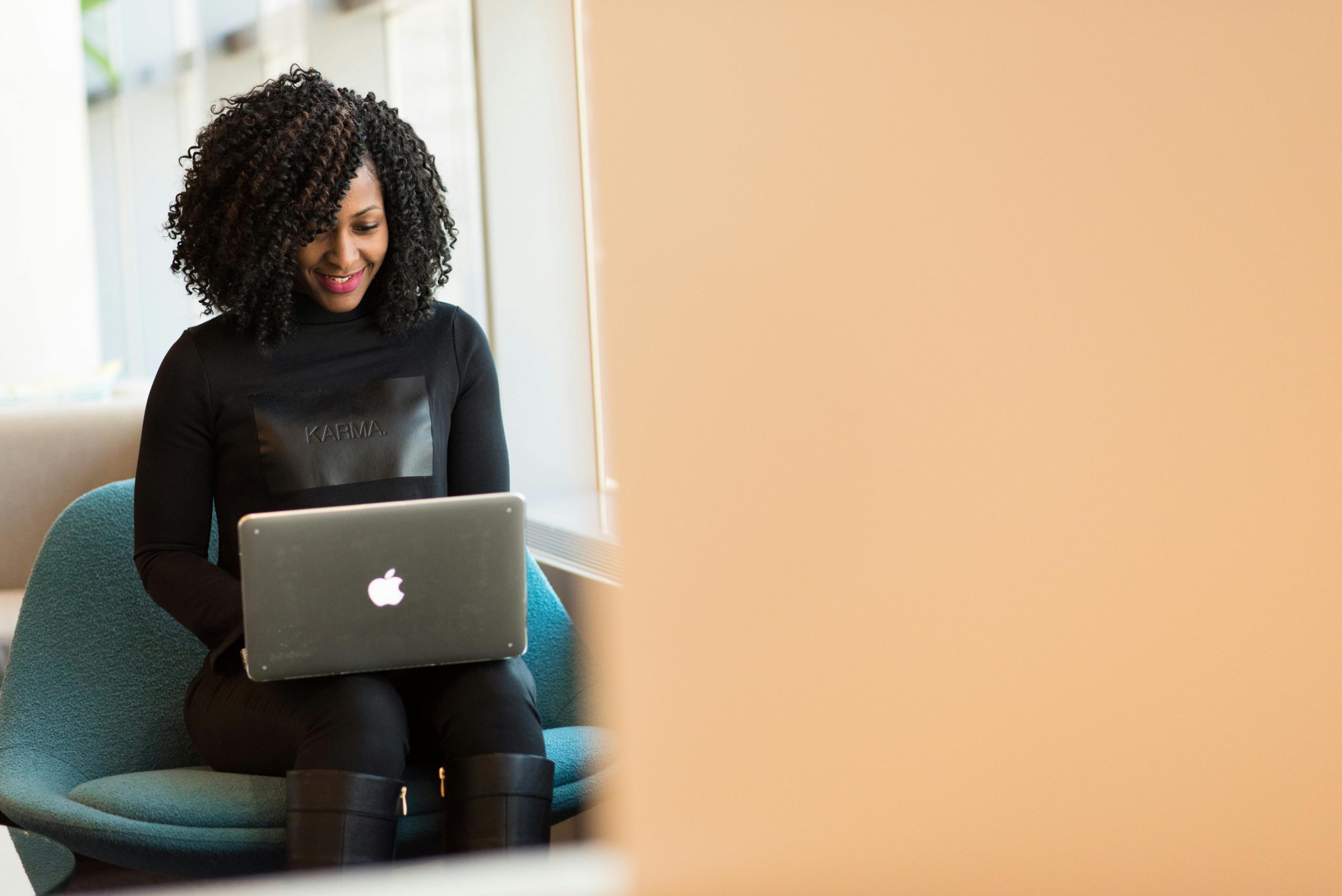 smiling woman using a MacBook